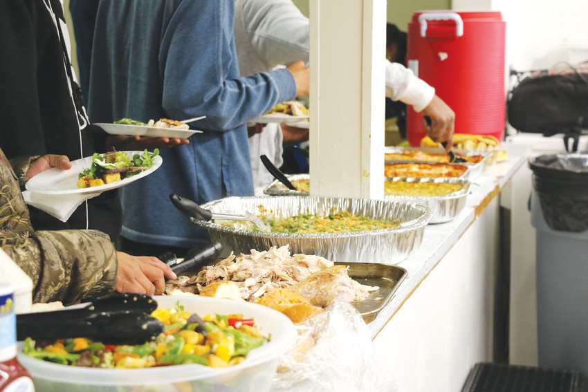 Homeless families at Mean Street Ministry’s shelter serve themselves dinner during the evening of Jan. 29. The shelter is open to families in need of a place to stay from December through April.