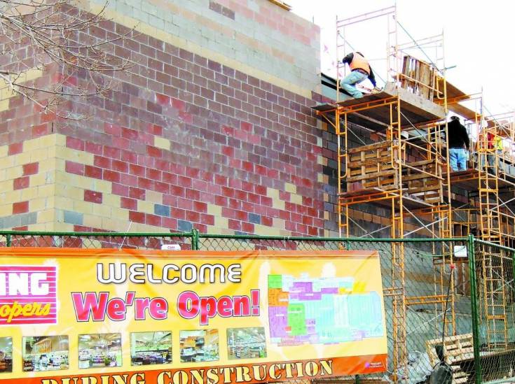 Construction workers do exterior brick work on Dec. 2 on the 18,000-square-foot expansion of the Cherrywood Square King Soopers, located at Dry Creek and Arapahoe roads.