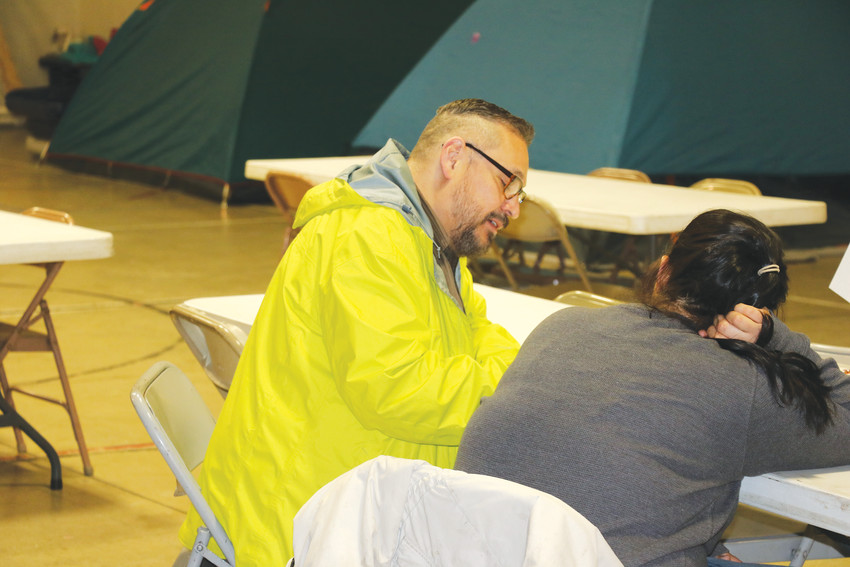 Tony Cisneros, a volunteer for the Point In Time Survey, interviews a homeless person staying the night at Mean Street Ministry’s shelter on Jan. 29.