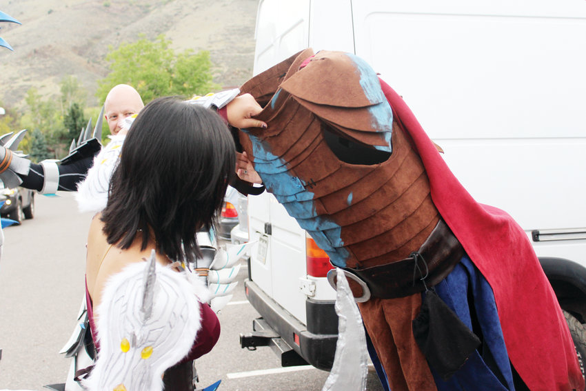 Elena Mathys helps Jennifer Losty take off the torso part of her Valka costume Sept. 16 at Lions Park in Golden.
