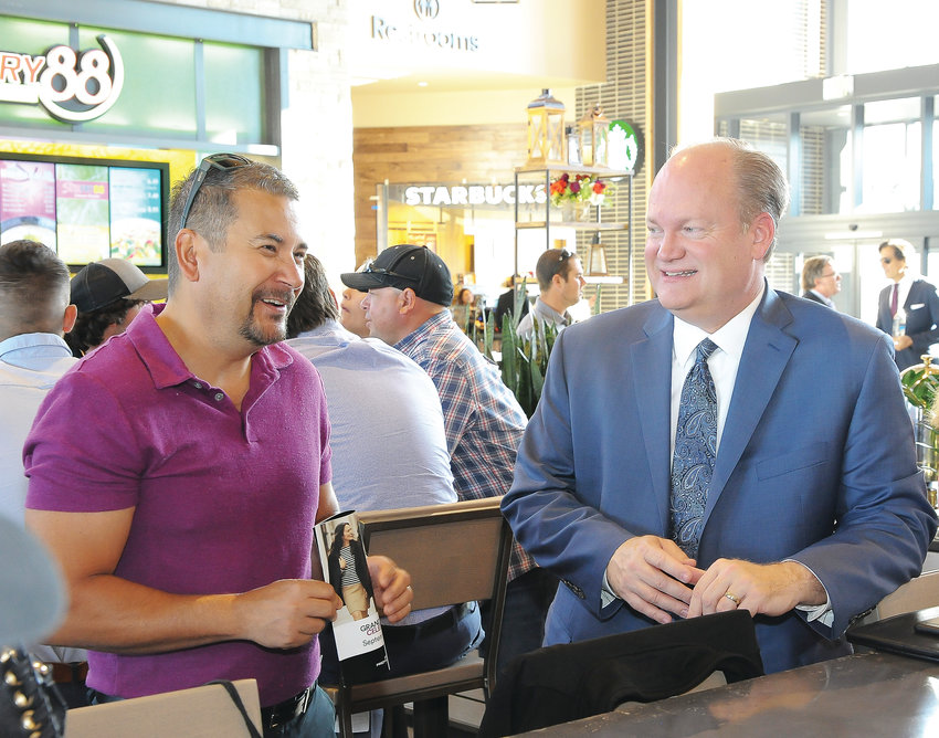 Greg Moss, president and CEO of Metro North Chamber of Commerce, right, visits with Vince Aragon, Thornton’s sponsorship and marketing coordinator, at a VIP breakfast before the official Sept. 27 opening of the new Denver Premium Outlet mall in Thornton.