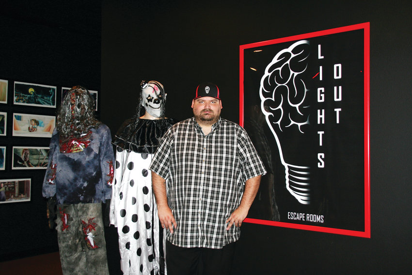 James Goodchild stands at the entrance of Lights Out! Escape Rooms and Social Lounge. Although horror-themed, the venue is not a haunted house and emphasis is put on solving the puzzles, rather than scare factor.