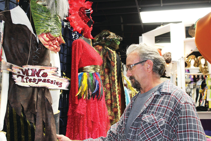 Dale Smith prepares for Halloween by shopping for costumes inside Disguises, a costume shop in Lakewood.