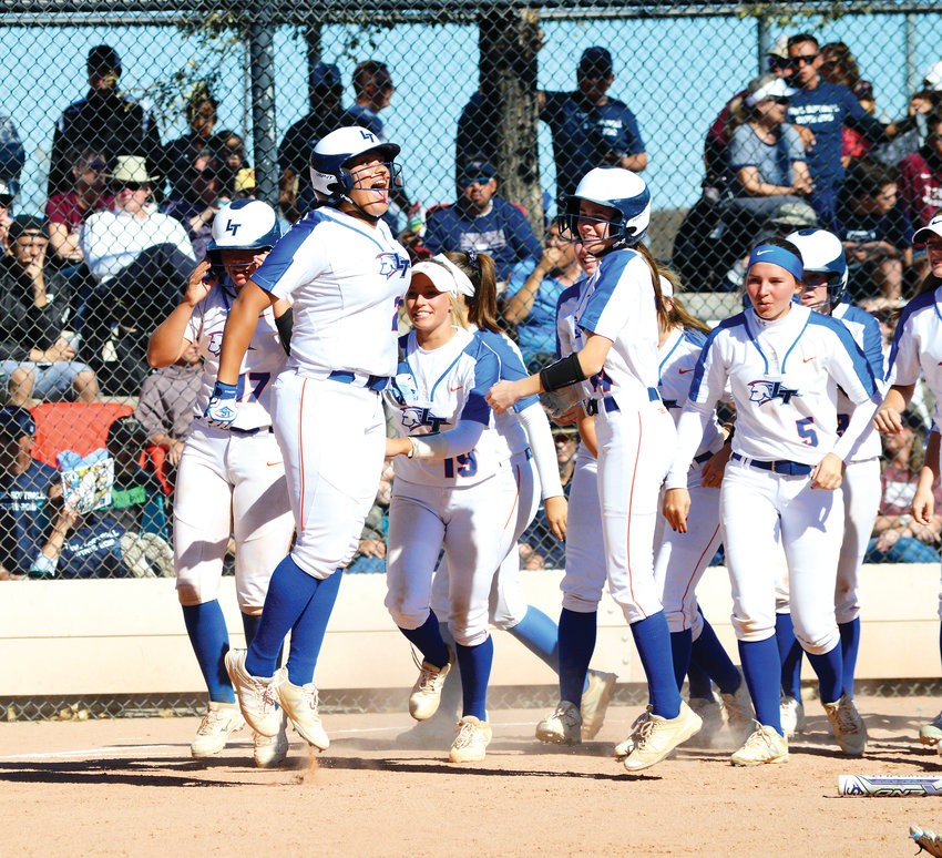 Lauren Griggs jumps for joy after crossing home plate following her two-run homer in the fourth inning which staked Legend to a 4-1 lead in the 5A state championship game played Oct. 20 at Aurora Sports Park. Legend won its second straight state title with an 8-4 victory over the top-seeded Cougars.