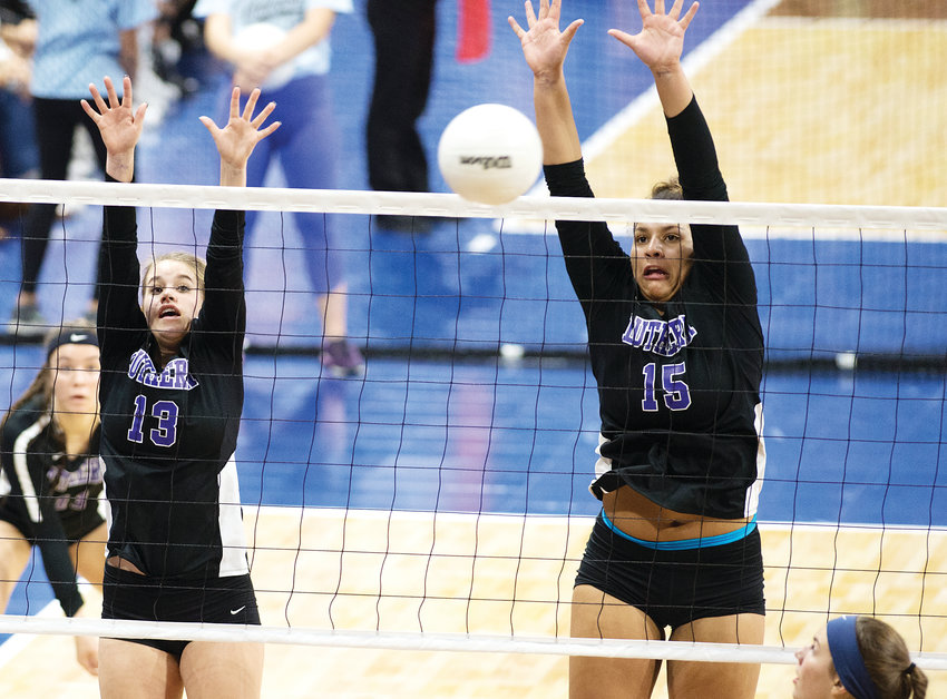 Lutheran's Kennedy Johnson (13) and Avery Anderson get in the successful block. The Lions ended up on top winning the state championship on Nov. 10.