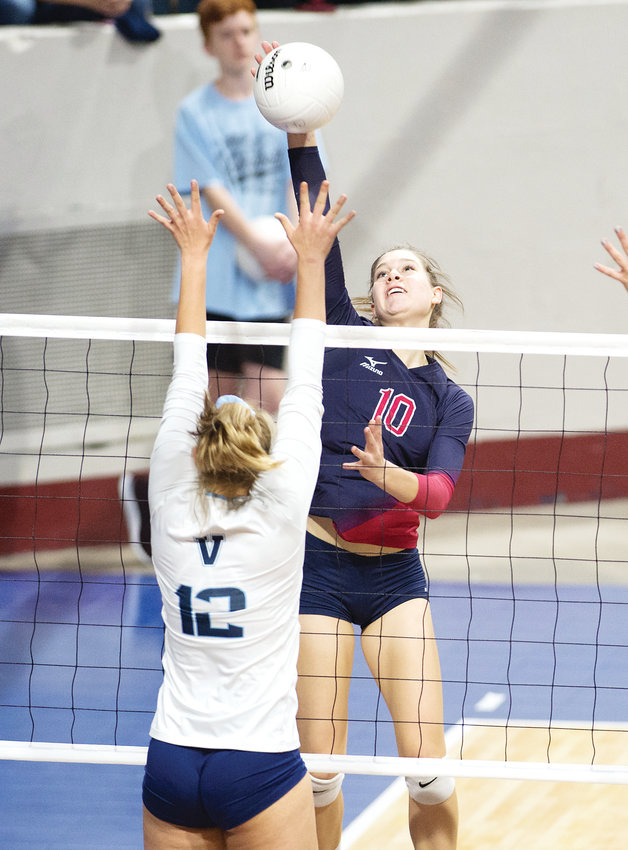 Chaparral's Morgan Riddle (10) lines up her kill as Valor Christian's Courtney Lane readies for the block.