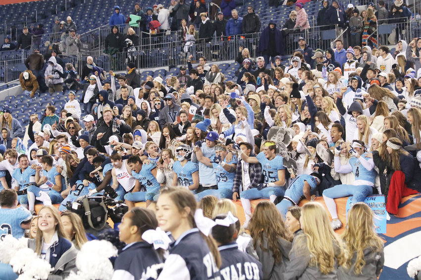 Valor players jump up and take a seat on the edge of the stands as Eagles fans gather behind them as the team celebrated winning the Class 5A state football championship.