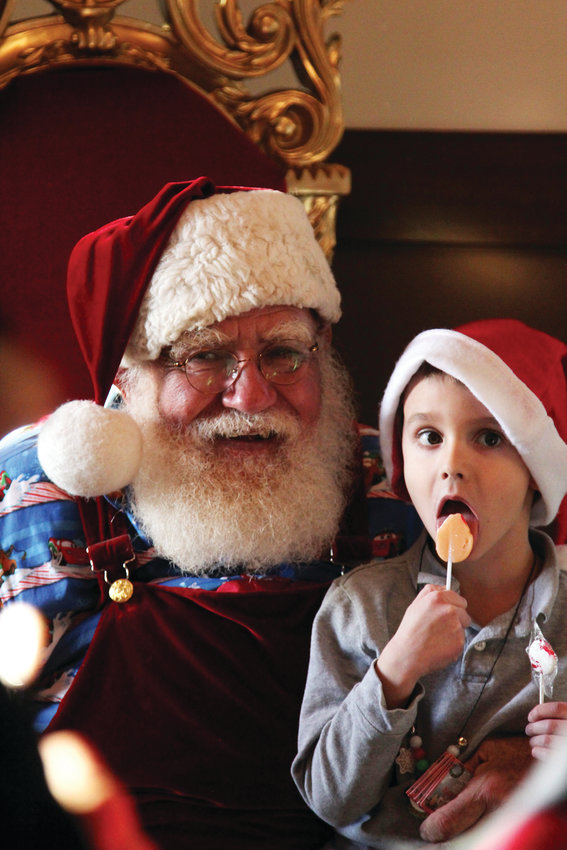 Miles Epstein, 5, visits with Santa at a Christmas festival in Castle Rock on Dec. 14.