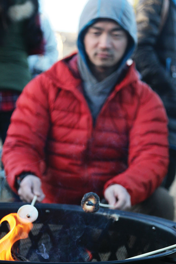 Boer Zhao of Castle Rock roasts marshmallows for his children during the Reindeer Games in Castle Rock.
