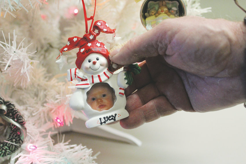 The "Christmas Tree of Lost Ornaments" is a collection of lost-and-found decorations with sentimental value, like this photo of Lucy on her first Christmas in 2005.