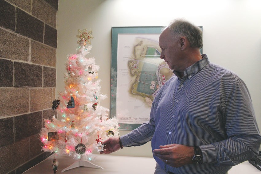 Randy Burkhardt of the Douglas County Parks and Trails Division with the "Christmas Tree of Lost Ornaments" at the division's Highlands Ranch office. The trees consists of sentimental ornaments found after yearly Christmas tree collection.