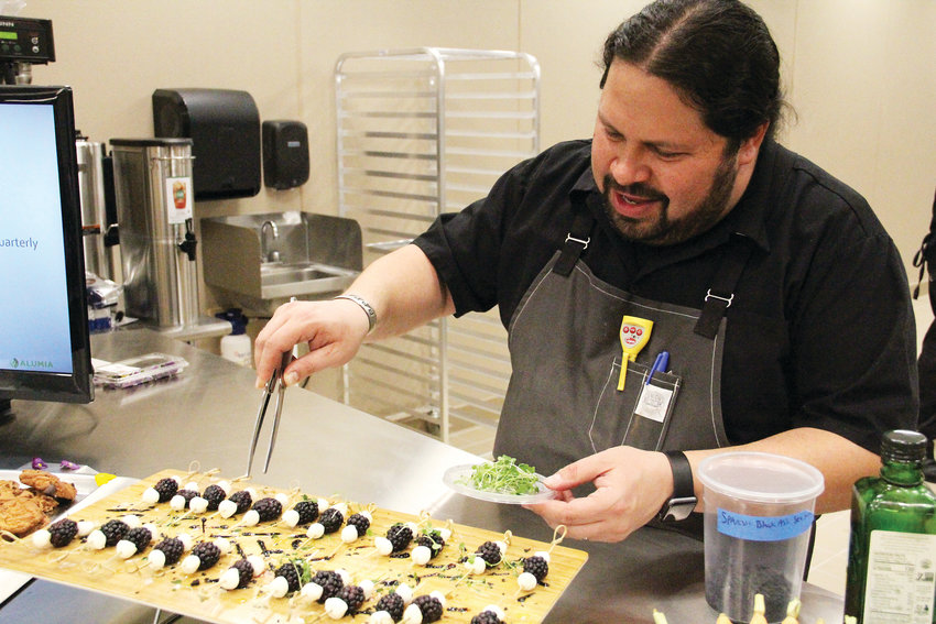 Daniel Asher, a well-known chef in the Denver area, tops food samples Dec. 18 at Alumia Institute, a therapy campus for those in the early stages of dementia, at 9800 E. Geddes Ave. Asher is the chef consultant for the campus and designed its nutritional plan.