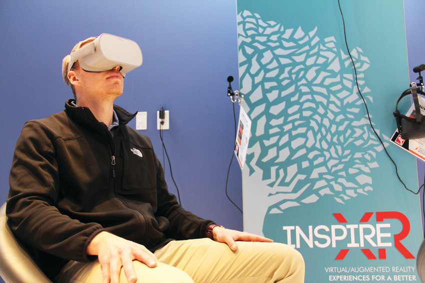 Ben Theune, spokesman for Wings Over the Rockies, uses a virtual-reality headset Jan. 17 that shows visitors what it’s like to fly a plane. That virtual content at the Boeing Blue Sky Aviation Gallery is created by Reality Garage in Boulder.