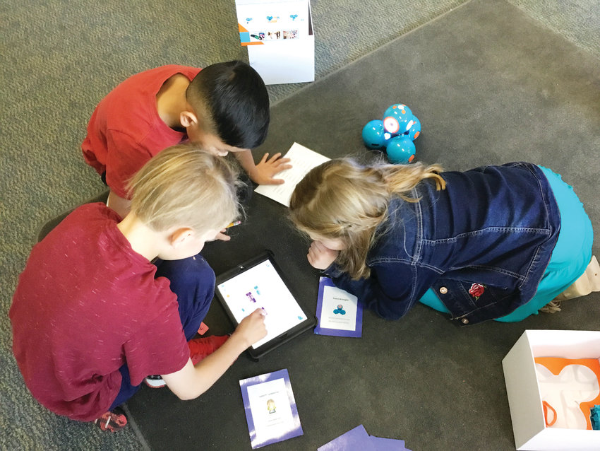 A group of third graders at Fairmount Elementary School in Golden work together on an activity called Coding Dash in the school’s STEM teacher Angie Blomquist’s classroom on Jan. 15.