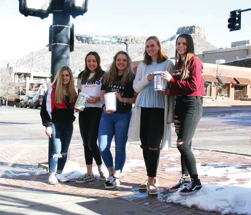 From left, Kristyn Kennedy, a senior at Lakewood High; Abbie McAdams, a junior at Wheat Ridge High; Isabella Hunt, a sophomore at Golden High; Elizabeth Becker, a senior at Ralston Valley High; and Brianna Fay, a sophomore at Ralston Valley High; gather on Washington Avenue in downtown Golden on Jan. 26 to generate conversation to raise awareness about teen mental health issues.