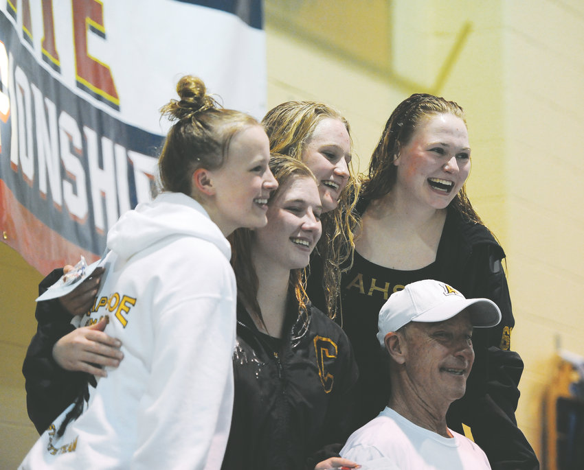 Diving coach Jeff Smith is surrounded by Arapahoe divers who qualified for the CHSAA Girls State Swimming and Diving championships. From left to right are Kyndall Tatum, Kirsten Belitz, who finished second in the finals, Morgan Hampton, who was seventh, and state champion Franny Cable.