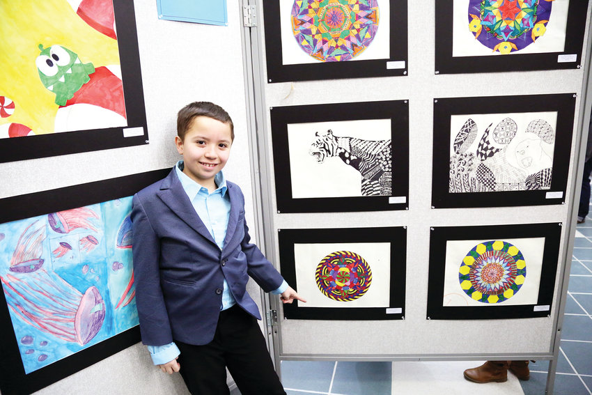 Weber Elementary student Marcus Mercado shows off his drawing at the opening reception of the 2019 Elementary Jeffco Schools Foundation Art Exhibit held Feb. 22.