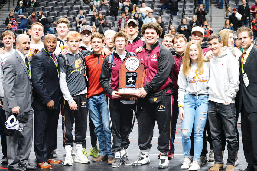 Senior state champions Mosha Schwartz (left) and Cohlton Schultz hold the runner-up trophy as Ponderosa finished second at the CHSAA State Wrestling Championships Feb. 23 at the Pepsi Center.