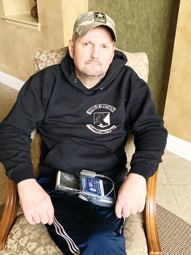 Christian Redman sits in the clubhouse of his Parker condominium complex, wearing the sweatshirt of his beloved Blackhorse regiment. Blackhorse veterans are planning a last ride for Redman, who is dying of cancer.