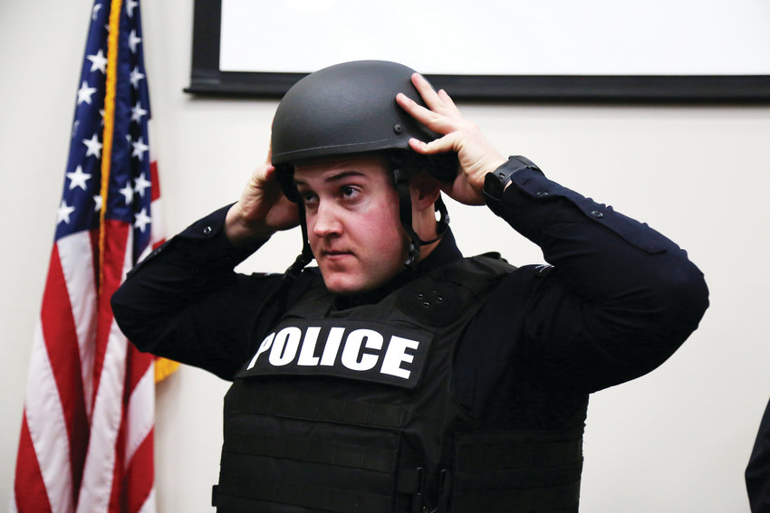 Arvada Police Officer Robert LoBosco tries on his new ballistic helmet and armor vest donated by SHIELD 616.