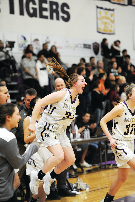 Holy Family’s Cecelia Aanerud, center, celebrates her team’s entrance into the CHSAA Girls 4A Final Four, during the closing seconds of the March 1 Great 8  playoff game against Greeley Central in Broomfield. The Tigers defeated the Wildcats 52-42, and will meet Mullen March 7, at the Denver Coliseum.
