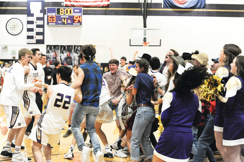 Holy Family students storm the floor following the Tigers' CHSAA Great 8 playoff win over Mead last Saturday, which earned Holy Family a trip to the Boys 4A Final Four. The Tigers will meet top-seeded Lewis-Palmer, Friday, March 8, at the Denver Coliseum.