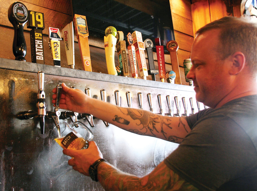 Noah Heaney, co-owner of Miners Saloon in Golden, pours a Batch 19 on March 1. The beer, recently re-released by AC Golden Brewing Company, is a pre-prohibition style lager.