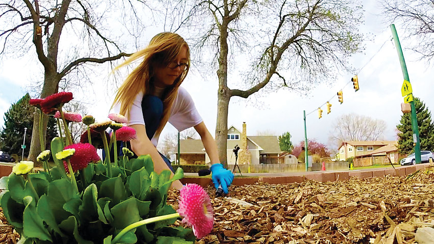 A Columbine student plants flowers at Dutch Creek Elementary School in April 2018 during the Day of Service.
