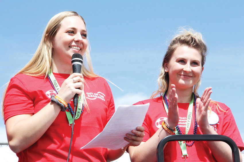 Arapahoe High School students Brooke Smiley, left, and Ry Renshaw address the crowd at the Out of the Darkness suicide-prevention walk April 14 on the Arapahoe campus in Centennial. The two students organized the event with the help of the American Foundation for Suicide Prevention.