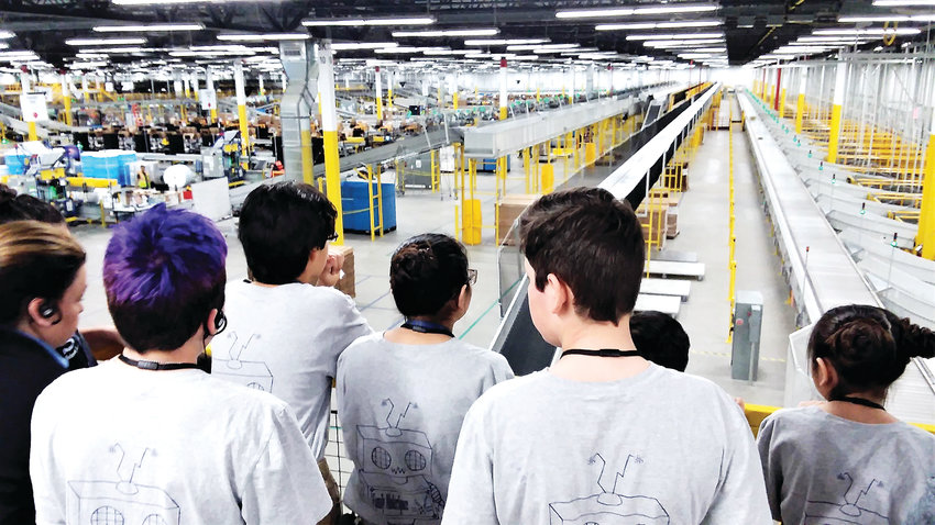 Students from Thornton’s STEM Launch School look out over the Thornton Amazon warehouse April 10 from a fourth floor vantage.