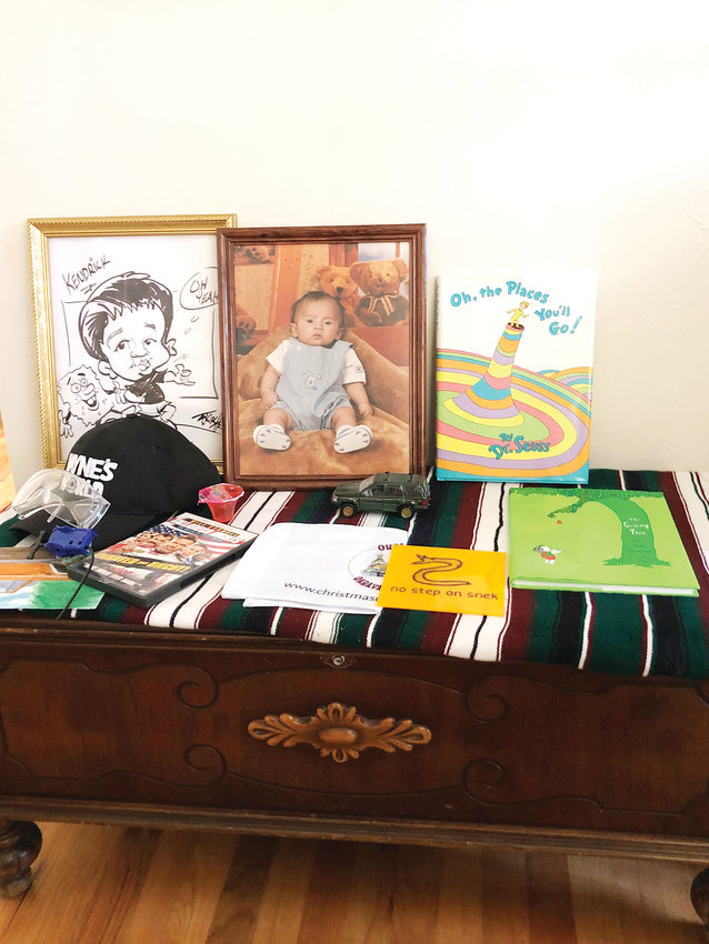 On Mother’s Day, friends of Kendrick Castillo add to a makeshift shrine in his parent’s dining room. Castillo was killed in a shooting at STEM High School on May 7.