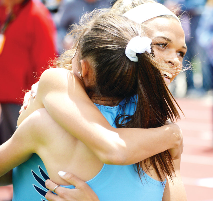 Valor Christian's Anna Hall hugs teammate Maddy Ortman after the finish of the 300 meter hurdles race. Hall won and Ortman was fourth.
