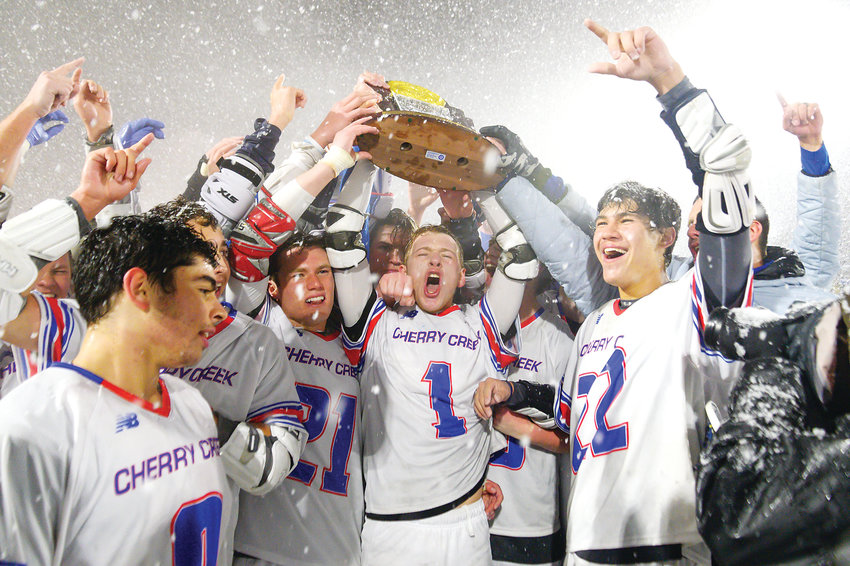 Cherry Creek's boys lacrosse team raises the Championship trophy as they celebrate their 12-7 victory over Kent Denver in the 5A State Final on May 20 at All City Field.