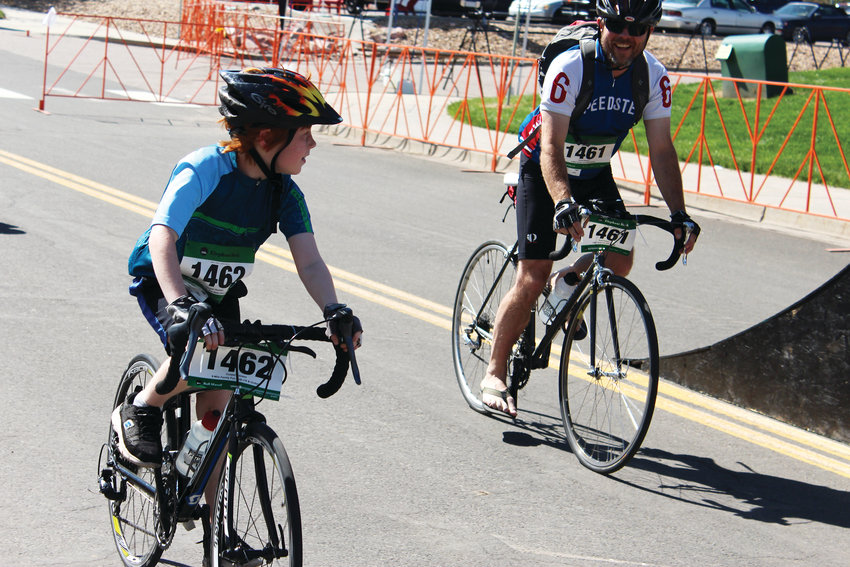 Two cyclists share a smile as they reach the finish of their ride at the Douglas County Fairgrounds June 2 at the Elephant Rock Ride.