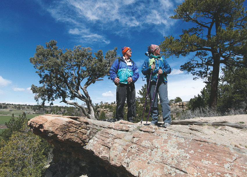 Two parkgoers stand atop a rocky area at Castlewood Canyon State Park near Castle Rock.