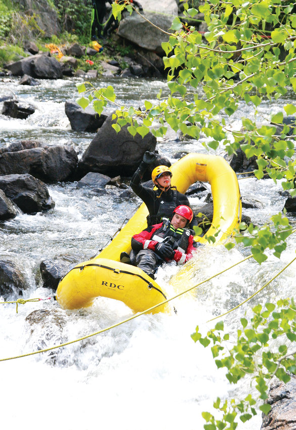 Rachel Kohler, an engineer with West Metro Fire Rescue, in the back of the raft, performs a mock swift water rescue on May 31 as part of the training to earn a swift water rescue technician certification. Kohler is one of 15 firefighters who earned the certification following this training.
