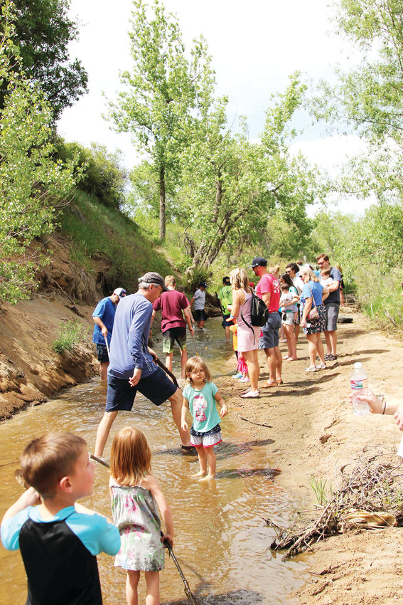 After rubber ducks had floated past families stayed behind to enjoy time near the creek.