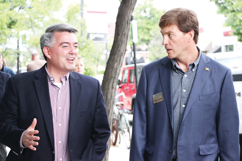 Senator Cory Gardner, left, chats with South Metro Denver Chamber of Commerce Chairman Andrew Graham on Main Street in Littleton on June 17.