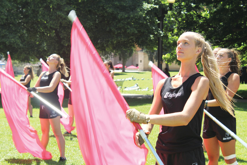 Katelyn Fabian with the Blue Knights Drum and Bugle Corps Color Guard practices before a performance at Civic Center park on June 20.