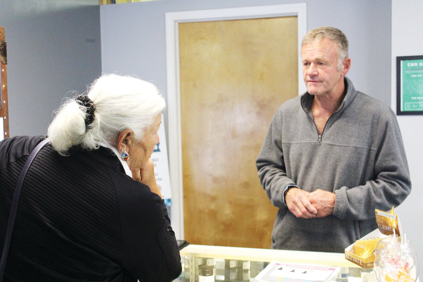 Todd Muck helps a customer at his business, Cannabis Bioscience Development in Franktown.