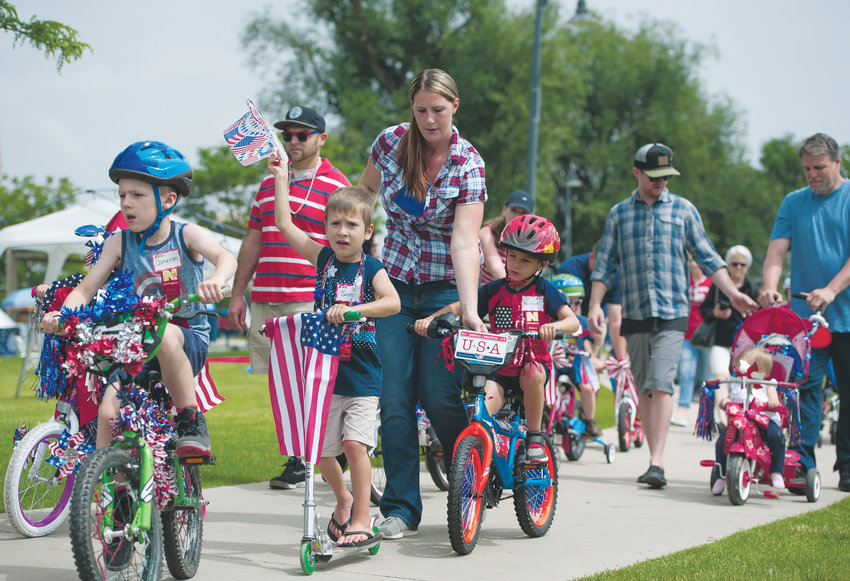 Young participants and their parents pedal the short course during Northglenn’s Pedals and Paws event, part of the city’s annual 4th of July celebration, at E. B. Rains, Jr. Memorial Park.