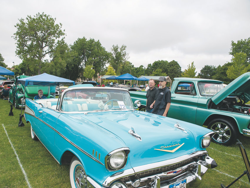 A 1957 Chevrolet Bel Air convertible attracts onlookers, during Northglenn’s Annual 4th of July Car Show, at E. B. Rains, Jr. Memorial Park. Owner Andy Wilson of Arvada, says the vehicle is painted “Tropical Turquoise”, and was originally manufactured in St. Louis, MO.