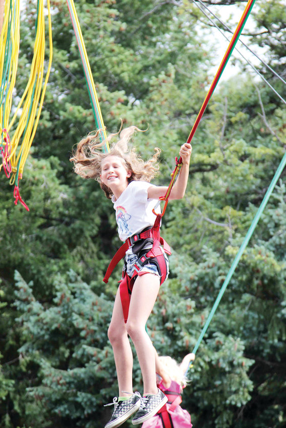 Games like bungee jumping entertain attendees of the Colorado Renaissance Festival.