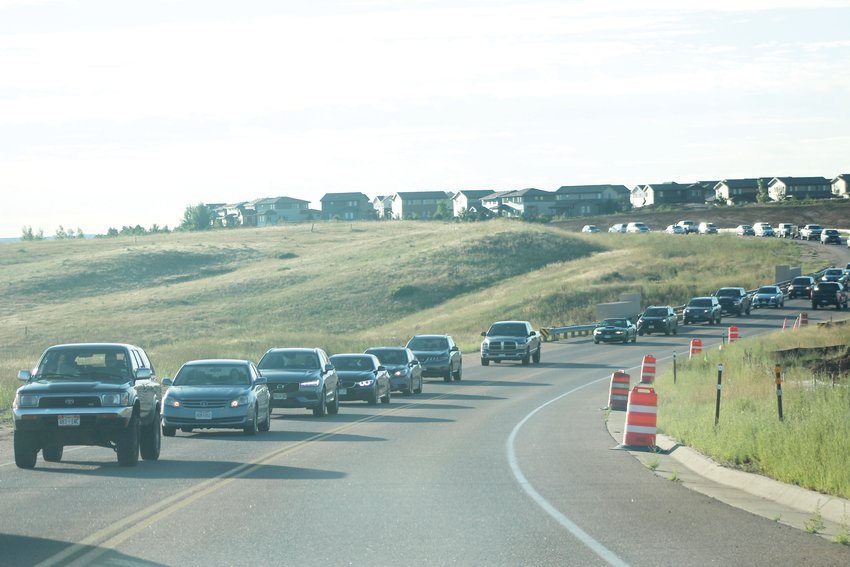 Cars travel west on RidgeGate Parkway from the Parker area during morning rush hour Aug. 12. The two-lane road will soon be expanded to four once the RidgeGate Parkway Widening Project finishes in 2021.