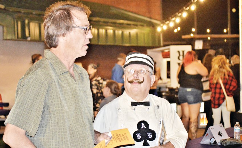 David Nielsen of Centennial, left, and Roger Hadix chat just outside the bar at Northglenn’s Magic Fest Aug. 17. Hadix, of Colorado Springs, said he wore his historic baseball costume to the festival, in keeping with the event’s masquerade theme.