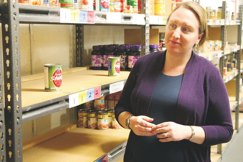 Allison Taggart, the program director at Integrated Family Community Services, surveys sparse shelves at the group's food bank. Donations to the group are flat, Taggart said, but the number of people needing food assistance just keeps growing, forcing IFCS to scale back the services it offers.