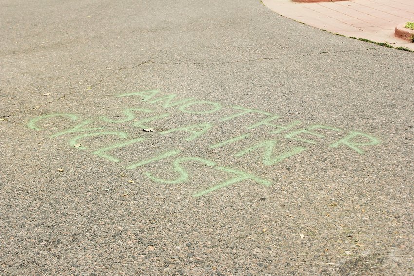 Graffiti in the street near where Alexis Bounds was hit and killed on her bike reads “another slain cyclist.” In response to the recent bicycle deaths in Denver, Mayor Michael B. Hancock announced in early August that the city would be lowering the speed limit on five arterial streets.