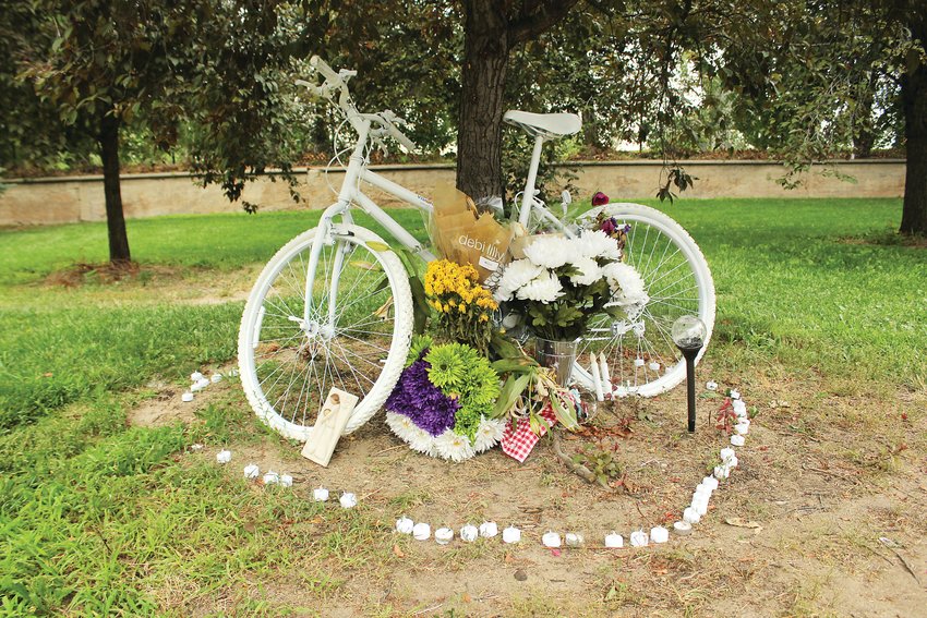 Alexis Bounds' ghost bike stands at the intersection of South Marion Parkway and East Bayaud Avenue where she was killed on July 24. Ghost bikes are placed as memorials of the person who was killed.