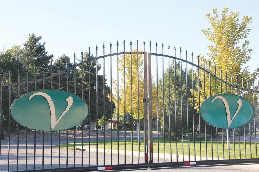 Gates at the south entrance to the Valley Club Acres neighborhood, where some homes sit just off a golf course. East of the gates, a Centennial shopping center is located along East Arapahoe Road.