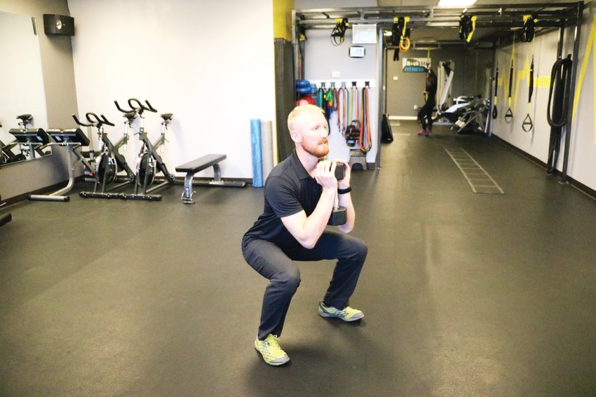 Cameron Davis, owner of RockStar Fitness in Castle Rock, completes a goblet squat using a dumbbell. One can also use a kettlebell, he said.